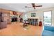 Inviting living room with a stone fireplace, wood floors, and ceiling fan at 4939 Myakka Valley Trl, Sarasota, FL 34241