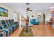 Bright living room with light wood floors, ceiling fan, and comfortable seating at 4939 Myakka Valley Trl, Sarasota, FL 34241