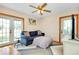 Cozy living room featuring a comfortable couch, stylish rug, and access to a screened porch, perfect for relaxing at 4939 Myakka Valley Trl, Sarasota, FL 34241