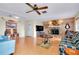 Comfortable living room with a stone fireplace, ceiling fan, and plenty of seating at 4939 Myakka Valley Trl, Sarasota, FL 34241