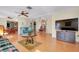 Cozy living room features wood floors, ceiling fan, and blue couch at 4939 Myakka Valley Trl, Sarasota, FL 34241