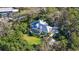 Aerial view of a home with a screened-in pool and lush landscaping, offering privacy and a natural setting at 4946 Hubner Cir Cir, Sarasota, Florida Area, FL 34241