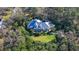 Aerial view of a sprawling home with a screened-in pool, surrounded by a lush green yard and dense trees at 4946 Hubner Cir Cir, Sarasota, Florida Area, FL 34241