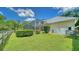 Landscaped backyard with a large grassy area at 4946 Hubner Cir Cir, Sarasota, Florida Area, FL 34241