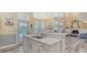 Open kitchen features a large island with white cabinets and quartz countertops at 4946 Hubner Cir Cir, Sarasota, Florida Area, FL 34241