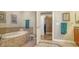 Bright bathroom features a soaking tub and an open doorway to a custom walk-in closet at 505 S Orange Ave # 501, Sarasota, FL 34236