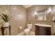 Chic powder room boasts patterned wallpaper, modern lighting, and an elegant vanity at 505 S Orange Ave # 501, Sarasota, FL 34236