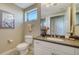 Bathroom with granite counters, white cabinets, tile floors, and a decorative piece of art at 505 S Orange Ave # 501, Sarasota, FL 34236