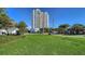 A high-rise building exterior with a lush lawn in front of the building at 505 S Orange Ave # 501, Sarasota, FL 34236