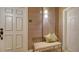 Hallway features a padded seat, neutral walls, and classic lighting fixture to welcome guests at 505 S Orange Ave # 501, Sarasota, FL 34236