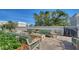 An exterior lounge area with a gas firepit surrounded by cushioned couches at 505 S Orange Ave # 501, Sarasota, FL 34236