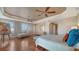 Bright main bedroom features hardwood floors, a decorative tray ceiling, and comfortable seating at 505 S Orange Ave # 501, Sarasota, FL 34236