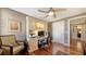 Cozy office space with a built-in desk, overhead storage, ceiling fan, and hardwood floors at 505 S Orange Ave # 501, Sarasota, FL 34236