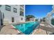 Exterior community pool with building and lounge area under blue sky at 505 S Orange Ave # 501, Sarasota, FL 34236