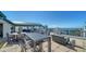 Enjoy outdoor dining on this rooftop deck with stunning water views and modern furniture, perfect for entertaining and relaxation at 505 S Orange Ave # 501, Sarasota, FL 34236