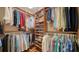 Spacious walk-in closet with wooden shelving, providing abundant storage space for clothing, shoes, and accessories at 505 S Orange Ave # 501, Sarasota, FL 34236