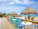 Beach bar with colorful chairs and thatch umbrellas at 5303 Coral Blvd, Bradenton, FL 34210