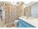 Bathroom with seashell shower curtain and vanity at 535 Spring Lakes Blvd, Bradenton, FL 34210
