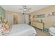 Bedroom with dresser, ceiling fan and coastal decor at 535 Spring Lakes Blvd, Bradenton, FL 34210