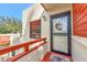 Condo entrance with a black metal door and a charming wreath at 535 Spring Lakes Blvd, Bradenton, FL 34210