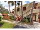 Condo building exterior with stairs and tropical landscaping at 535 Spring Lakes Blvd, Bradenton, FL 34210