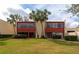 Condo building with red accents and palm trees in front at 535 Spring Lakes Blvd, Bradenton, FL 34210