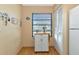 Small kitchen with a rolling kitchen island and white cabinets at 535 Spring Lakes Blvd, Bradenton, FL 34210