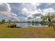 Scenic lake view with lush greenery and partly cloudy sky at 535 Spring Lakes Blvd, Bradenton, FL 34210