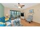 Living room with blue sofa, glass top coffee table and access to a screened porch at 535 Spring Lakes Blvd, Bradenton, FL 34210