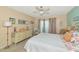 Main bedroom with a dresser, large bed and access to a balcony at 535 Spring Lakes Blvd, Bradenton, FL 34210