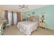 Main bedroom with a large bed, ceiling fan and access to a balcony at 535 Spring Lakes Blvd, Bradenton, FL 34210