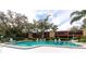 Community pool with surrounding lounge chairs and trees at 535 Spring Lakes Blvd, Bradenton, FL 34210