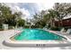 Community swimming pool with lounge chairs and a depth of 6ft 3in at 535 Spring Lakes Blvd, Bradenton, FL 34210