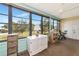 Screened porch with white cabinet, exercise bike and view of the backyard at 535 Spring Lakes Blvd, Bradenton, FL 34210