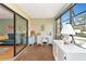 Bright screened porch with white furniture and access to the outdoors at 535 Spring Lakes Blvd, Bradenton, FL 34210