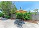 Private backyard features landscaping, wooden fence and patio seating at 5376 Royal Palm Ave # 5376, Sarasota, FL 34234