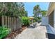 Private backyard features landscaping, wooden fence and patio seating at 5376 Royal Palm Ave # 5376, Sarasota, FL 34234