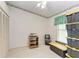 Neutral bedroom features a ceiling fan, window, shelving and closet at 5376 Royal Palm Ave # 5376, Sarasota, FL 34234