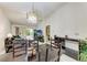 Bright dining area with modern chandelier, spacious layout, and views into the living room at 5376 Royal Palm Ave # 5376, Sarasota, FL 34234