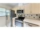 Kitchen features stainless steel appliances, neutral countertops, and tile backsplash at 5376 Royal Palm Ave # 5376, Sarasota, FL 34234