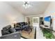 Comfortable living room with leather furniture, fan and sliding glass doors leading to the lanai at 5376 Royal Palm Ave # 5376, Sarasota, FL 34234