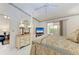 Main bedroom with a four-poster bed, dresser, and sliding glass doors at 5376 Royal Palm Ave # 5376, Sarasota, FL 34234
