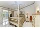 Main bedroom features a four-poster bed and sliding glass doors at 5376 Royal Palm Ave # 5376, Sarasota, FL 34234