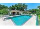 Community pool features ample seating, clear blue water and shady trees at 5376 Royal Palm Ave # 5376, Sarasota, FL 34234