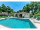 Community pool features ample seating, clear blue water and shady trees at 5376 Royal Palm Ave # 5376, Sarasota, FL 34234