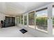 Bright sunroom offers tile flooring, windows with backyard views, and storage at 5376 Royal Palm Ave # 5376, Sarasota, FL 34234