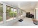 Bright sunroom offers tile flooring, windows with backyard views, and storage at 5376 Royal Palm Ave # 5376, Sarasota, FL 34234