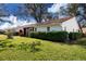 Landscaped backyard with lush greenery and screened patio at 5807 Garden Lakes Fern # 5807, Bradenton, FL 34203