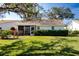 House with backyard, lush green grass, and screened patio at 5807 Garden Lakes Fern # 5807, Bradenton, FL 34203