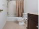 Clean bathroom with tub, toilet, and dark brown vanity at 5807 Garden Lakes Fern # 5807, Bradenton, FL 34203